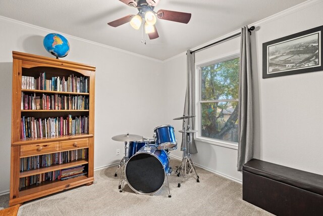 misc room with light carpet, crown molding, and ceiling fan