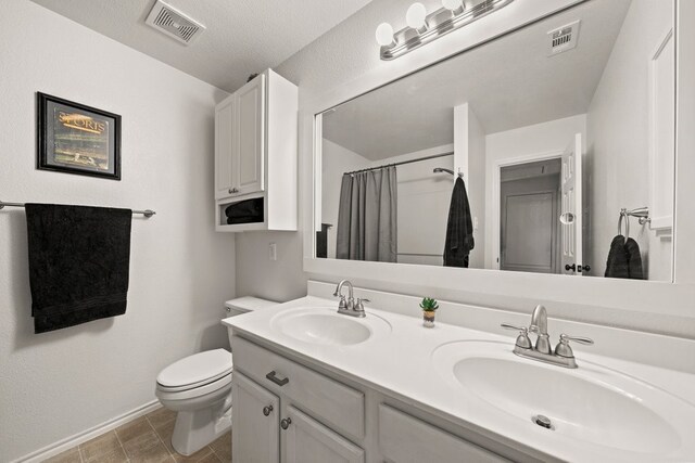 bathroom with vanity, toilet, and walk in shower