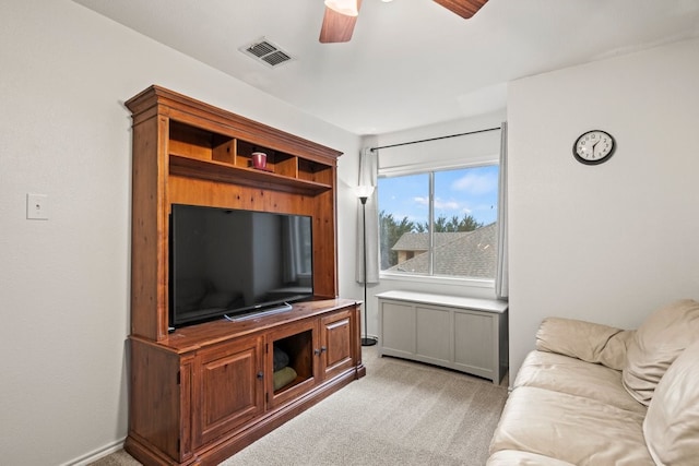 living room featuring ceiling fan and light colored carpet