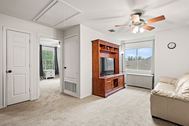 living room featuring light colored carpet and ceiling fan