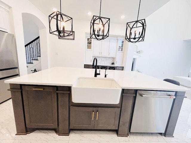 kitchen with sink, an island with sink, white cabinets, and appliances with stainless steel finishes