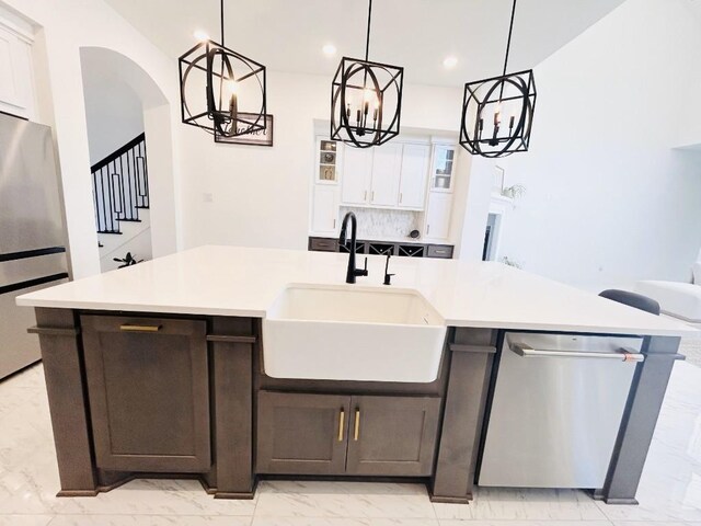 kitchen featuring sink, an island with sink, white cabinets, and appliances with stainless steel finishes