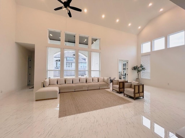 living room featuring high vaulted ceiling and ceiling fan