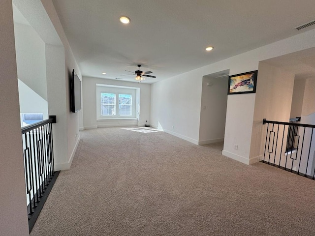 carpeted spare room featuring ceiling fan