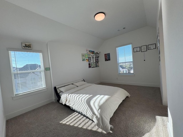 bedroom with lofted ceiling and dark carpet