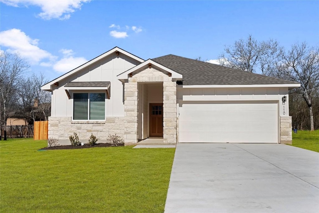 view of front of property with a garage and a front lawn