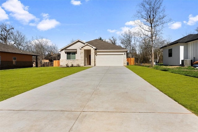 view of front facade featuring a garage, central AC unit, and a front lawn