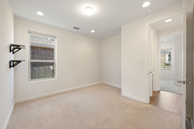 unfurnished room with light colored carpet