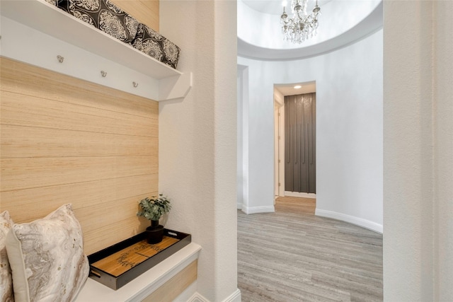 mudroom featuring a chandelier and hardwood / wood-style floors