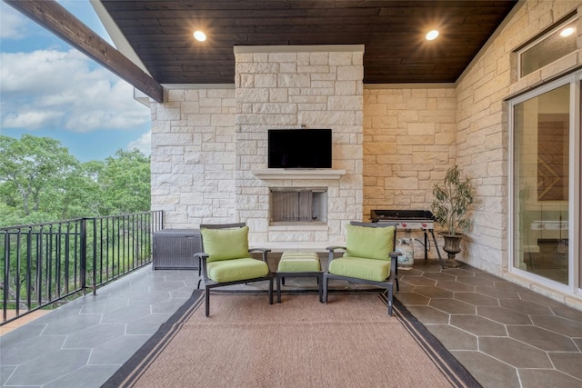 balcony with an outdoor stone fireplace