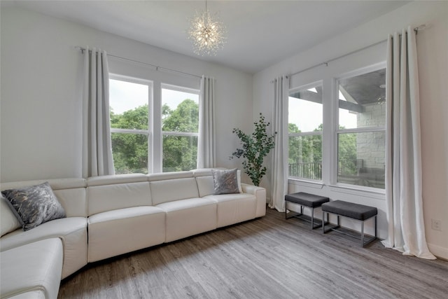 living room with an inviting chandelier and hardwood / wood-style flooring