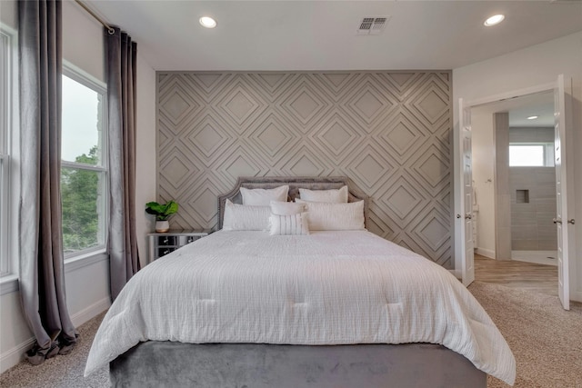 carpeted bedroom featuring multiple windows