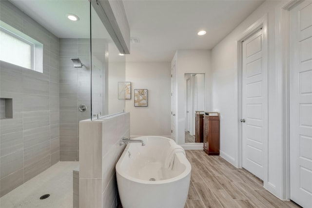 bathroom with separate shower and tub