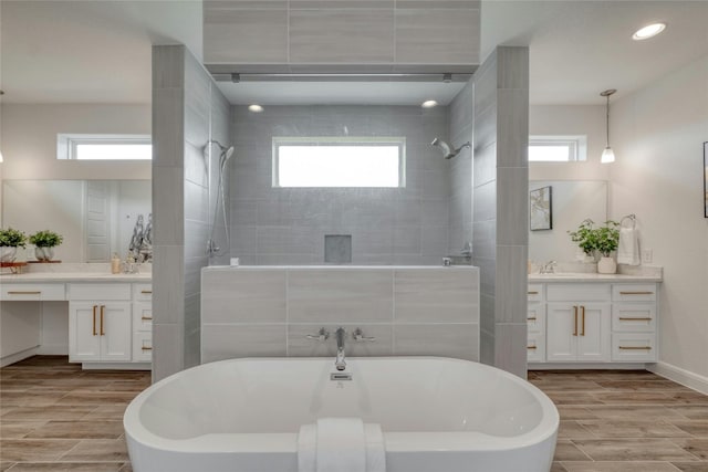 bathroom with vanity, plenty of natural light, and shower with separate bathtub