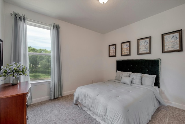 bedroom featuring light colored carpet