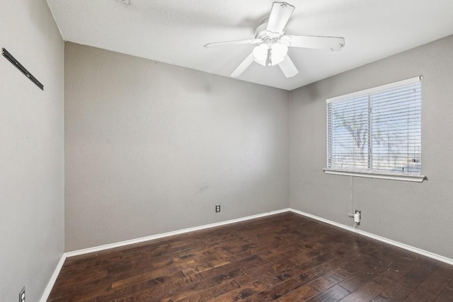 spare room with dark hardwood / wood-style floors and ceiling fan