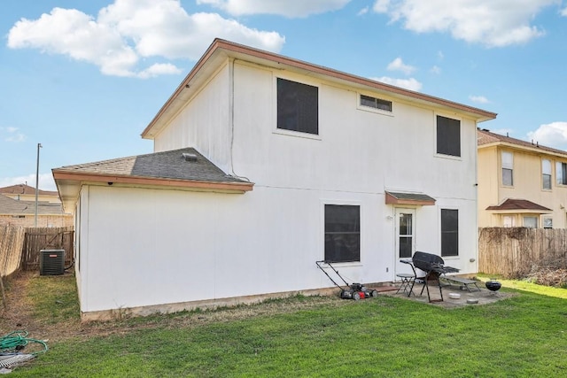 back of house with a lawn, a patio area, and central air condition unit