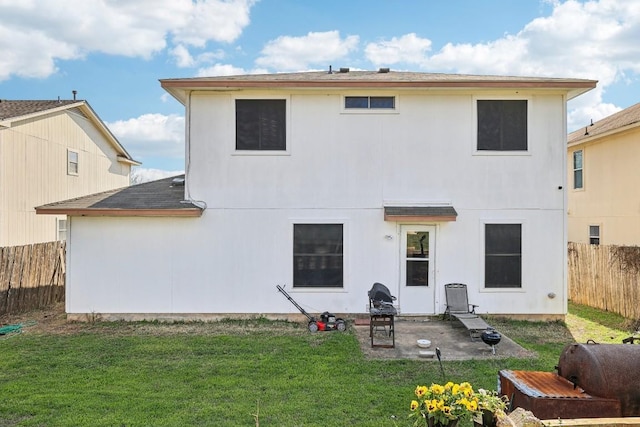 back of property featuring a yard and a patio