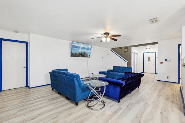 living room with ceiling fan and light hardwood / wood-style floors