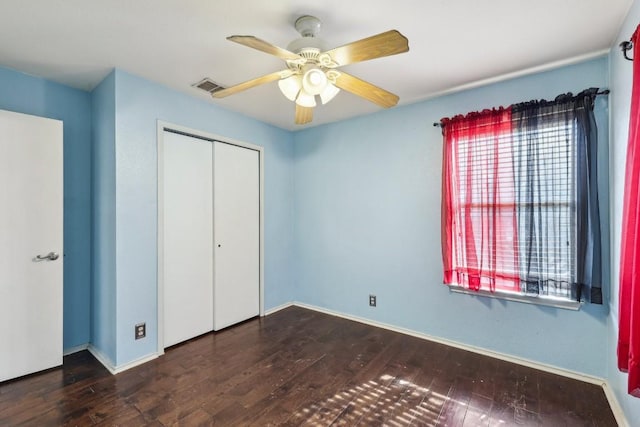 unfurnished bedroom featuring hardwood / wood-style flooring, ceiling fan, and a closet