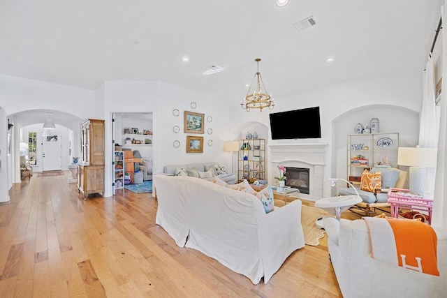 living room featuring light hardwood / wood-style flooring and a chandelier