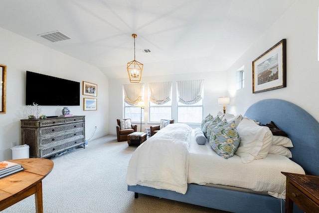 carpeted bedroom featuring vaulted ceiling and a notable chandelier