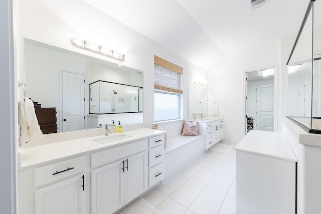 bathroom featuring tile patterned floors, vanity, and a shower with shower door