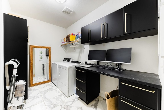 laundry area with washer and dryer and cabinets