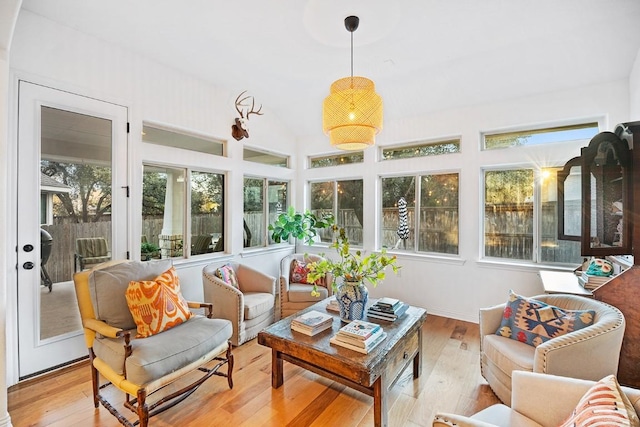 sunroom / solarium featuring lofted ceiling