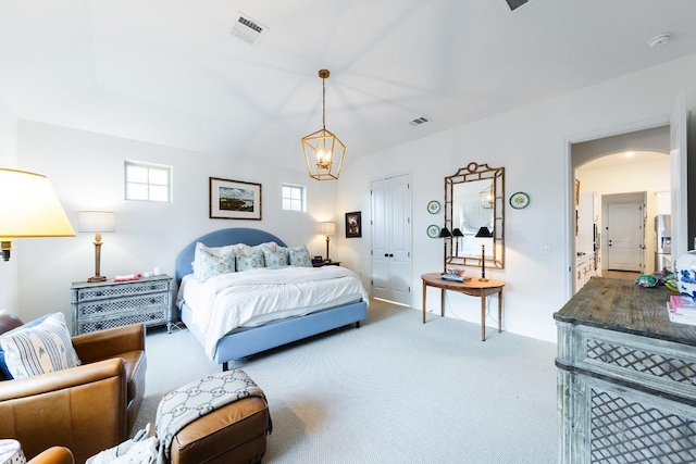 carpeted bedroom with a notable chandelier