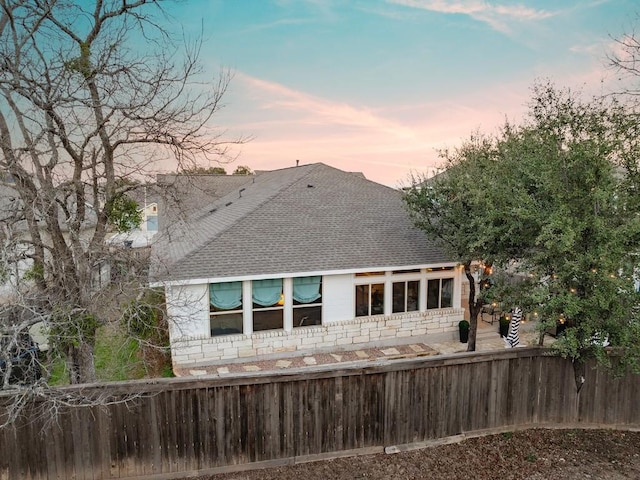 view of back house at dusk