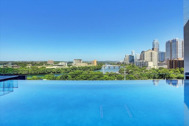 view of swimming pool with a water view