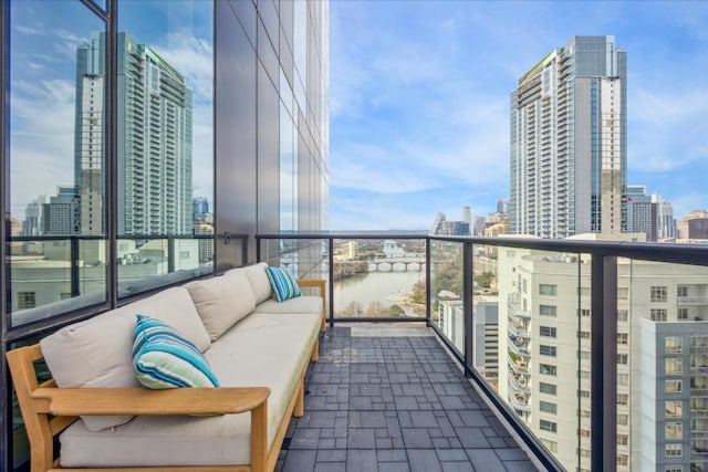 balcony featuring a water view and an outdoor hangout area