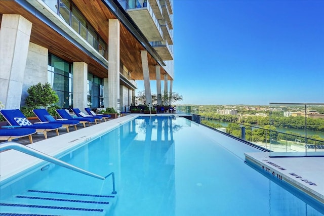 view of pool with a water view