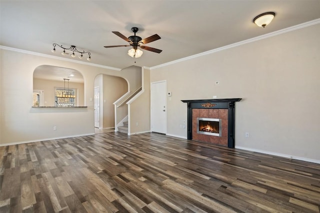 unfurnished living room with ornamental molding, dark hardwood / wood-style floors, and a fireplace