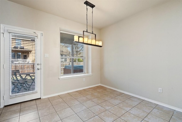 unfurnished dining area featuring a notable chandelier and light tile patterned flooring