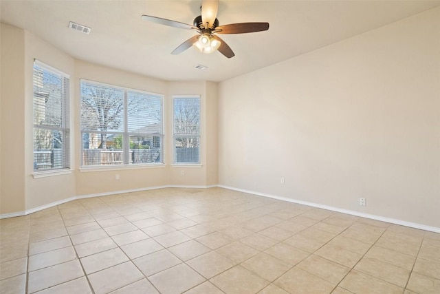 spare room featuring light tile patterned flooring and ceiling fan