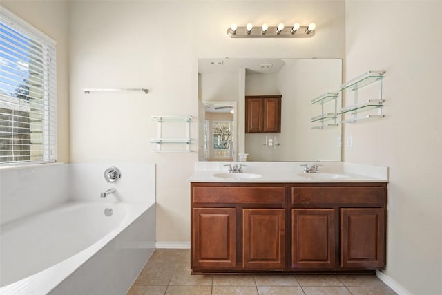 bathroom featuring vanity, a bath, and tile patterned floors