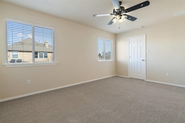 carpeted empty room featuring ceiling fan