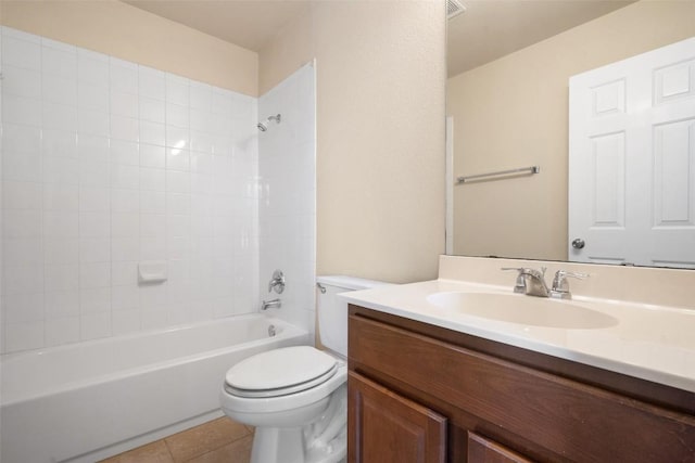 full bathroom with tiled shower / bath, vanity, tile patterned floors, and toilet