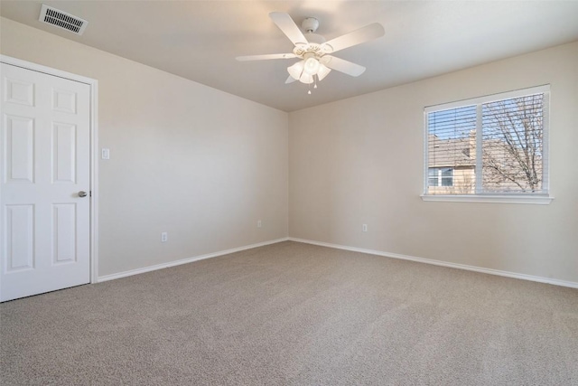 empty room with carpet flooring and ceiling fan