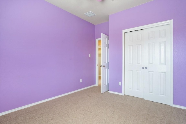 unfurnished bedroom featuring carpet flooring and a closet