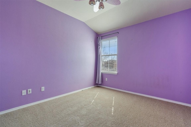 carpeted spare room with vaulted ceiling and ceiling fan