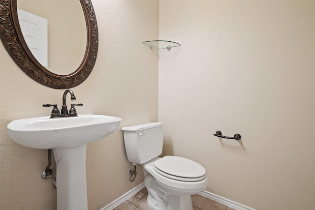 bathroom with tile patterned floors and toilet