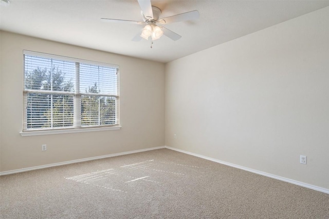 carpeted spare room with ceiling fan