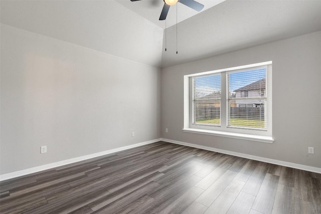 empty room featuring lofted ceiling, dark wood-type flooring, and ceiling fan