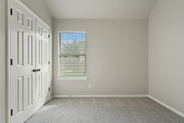 unfurnished bedroom with light carpet and a closet