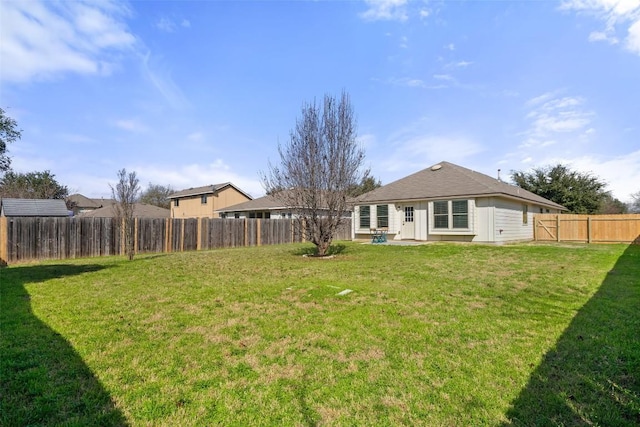 rear view of house featuring a lawn and a patio area