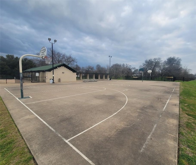 view of basketball court with community basketball court and fence