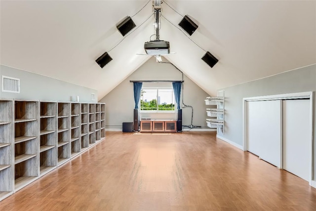 bonus room featuring hardwood / wood-style flooring and lofted ceiling